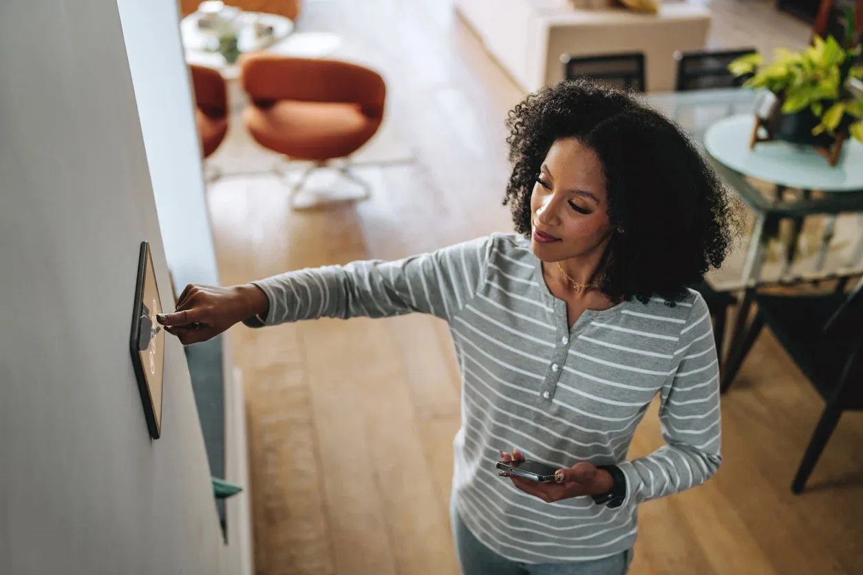 Woman adjusting a smart home system